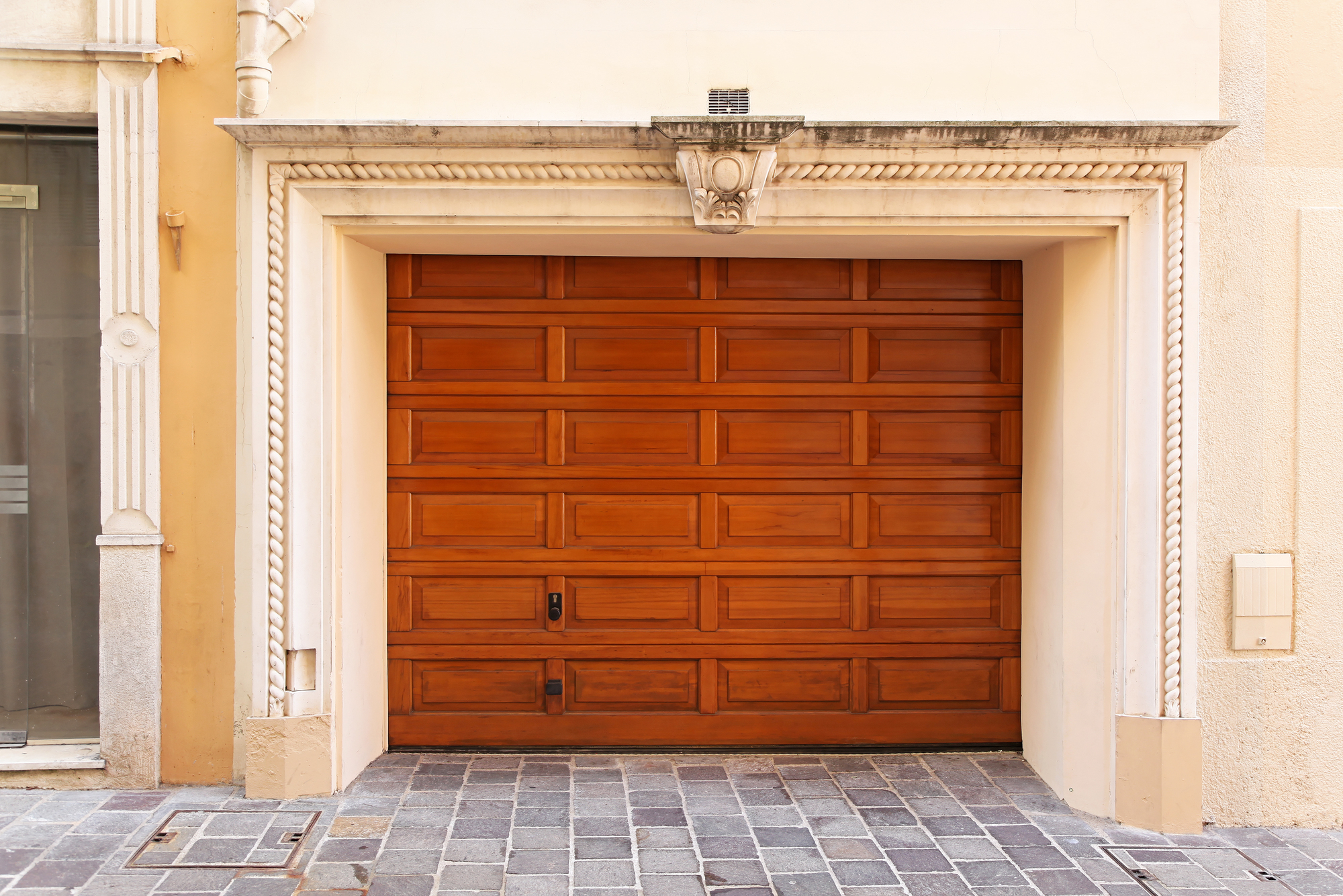 Wide wooden garage door at luxury home